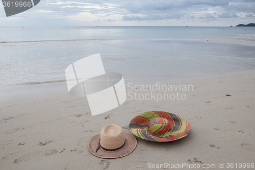 Image of Beach on tropical island. Clear blue water, sand, clouds. 