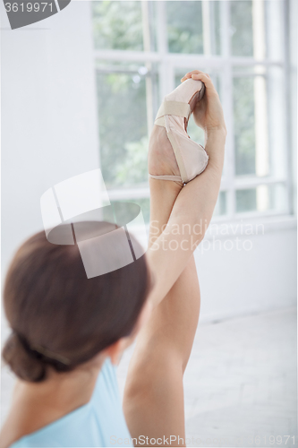 Image of young modern ballet dancer posing on white background