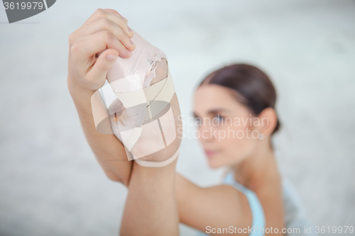 Image of young modern ballet dancer posing on white background