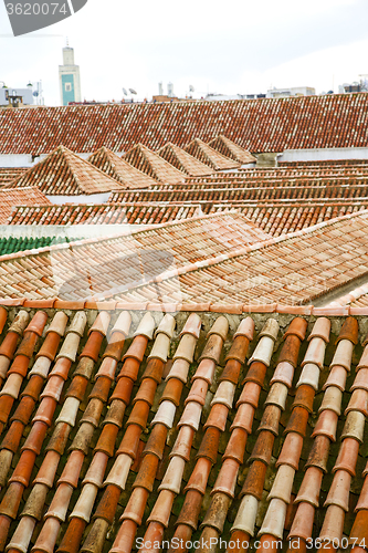 Image of minaret old moroccan  tile roof in the  