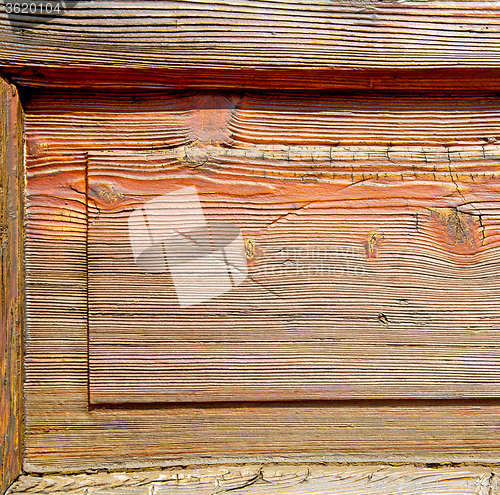 Image of grain texture of a brown antique wooden old door in italy   euro