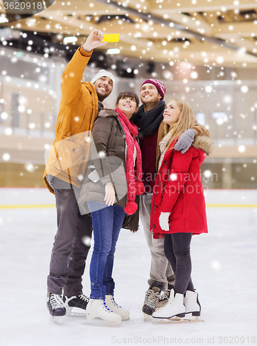 Image of happy friends taking selfie on skating rink