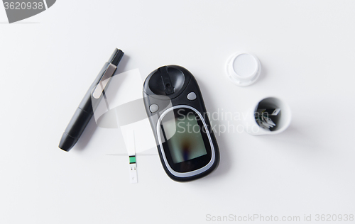 Image of close up of glucometer and blood sugar test stripe