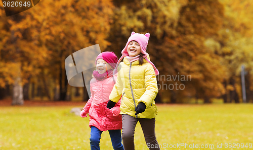 Image of group of happy little girls running outdoors