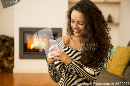 Image of Woman with her cellphone at home