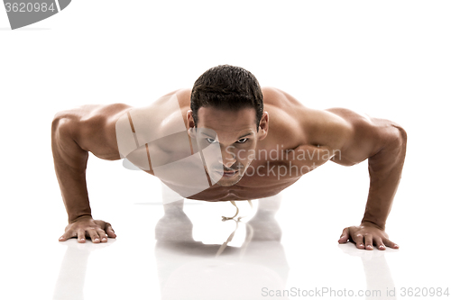 Image of Muscle man making pushups