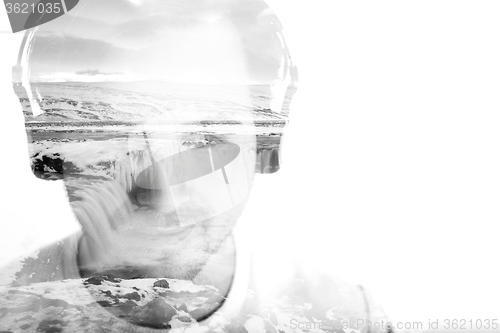 Image of Young man with headphones and waterfall, double exposure