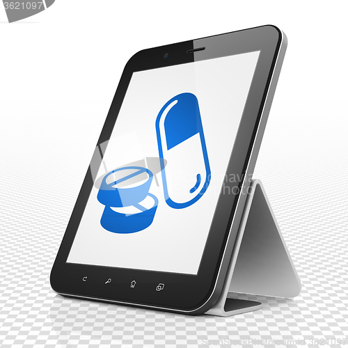 Image of Medicine concept: Tablet Computer with Pills on display