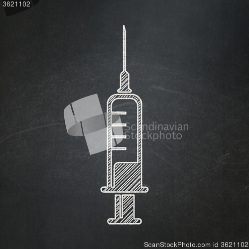 Image of Healthcare concept: Syringe on chalkboard background