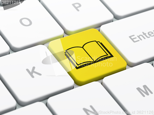 Image of Science concept: Book on computer keyboard background