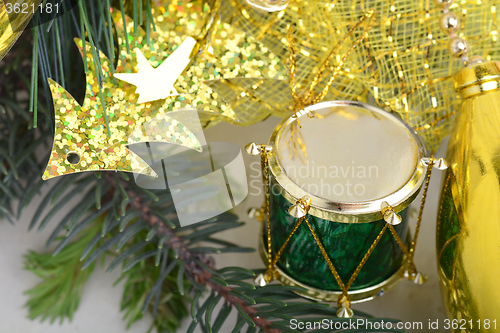 Image of Christmas background with drums, green eve tree branch, golden new year decoration 