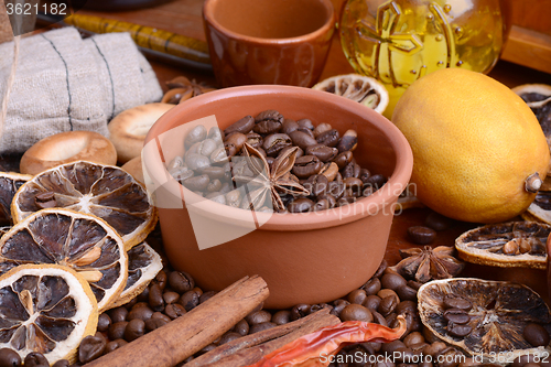 Image of coffee beans, candle, old bottle, vintage clock, lemon, cinnamon, anise and aroma spice