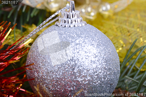 Image of Closeup of Christmas balls and green fir tree branch, new year invitation card