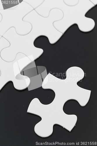 Image of White puzzle on black background