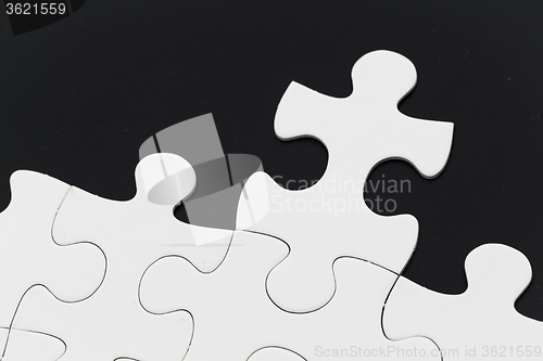 Image of White puzzle on black background