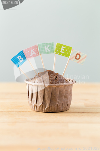Image of Chocolate muffins with small flag of a word baked