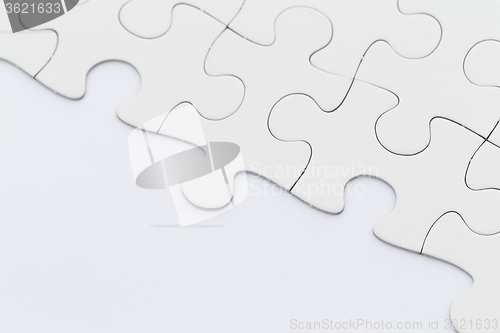 Image of White incomplete jigsaw puzzle