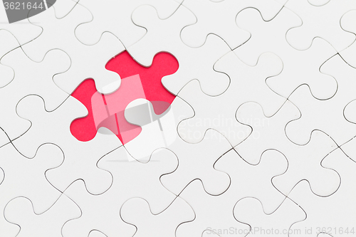 Image of Puzzle with missing piece over red background