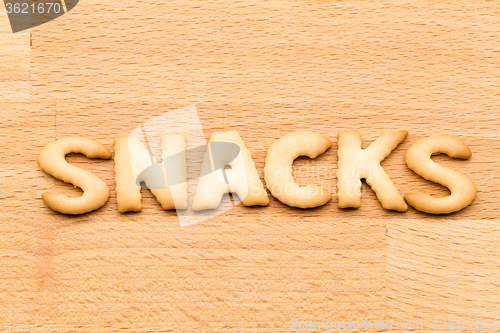 Image of Word snacks cookie over the wooden background