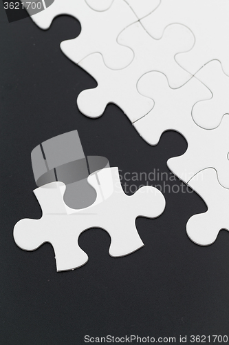 Image of Plain white jigsaw puzzle on black background