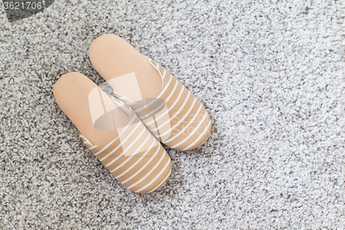 Image of Pair of slippers on carpet