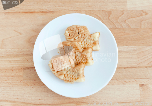 Image of Taiyaki of japanese traditional baked sweets on wooden table