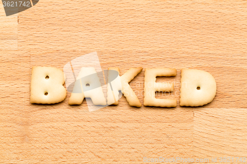 Image of Word baked biscuit over the wooden background