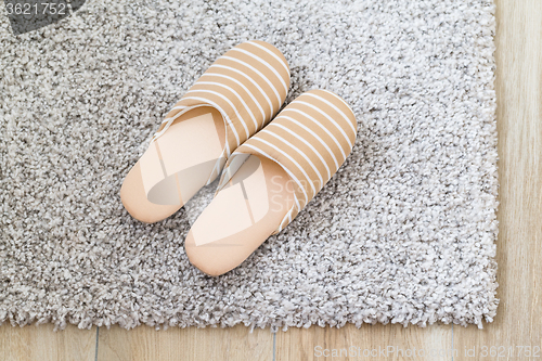 Image of Slippers on grey carpet