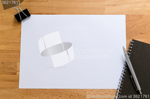 Image of Working desk with plain paper for adding some information