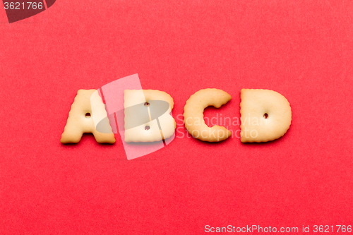 Image of ABCD cookie over the red background