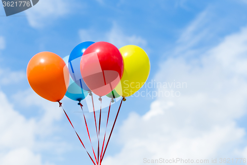 Image of Bunch of colorful balloons in the blue sky