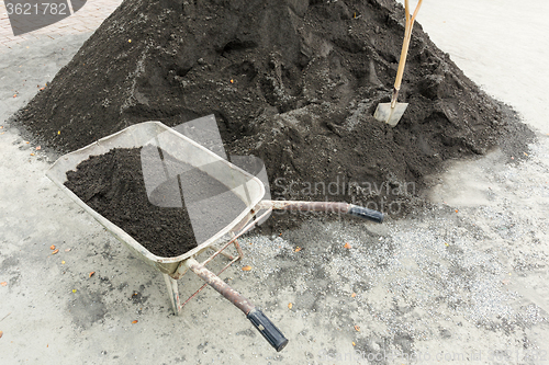 Image of Shovel for construction works on a heap of old asphalt