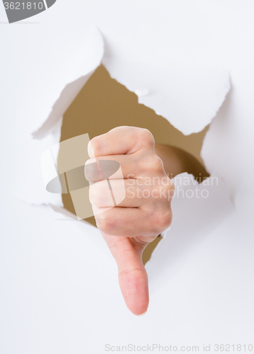 Image of Dislike gesture break through the paper wall