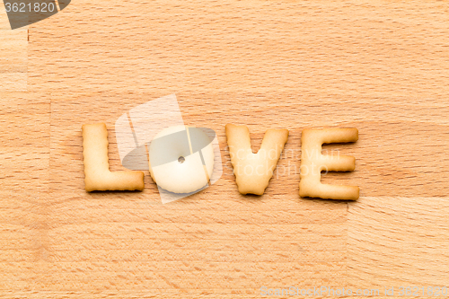 Image of Word Love biscuit over the wooden background