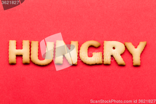 Image of Word hungry cookie over the red background