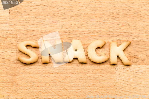Image of Word snack biscuit over the wooden background