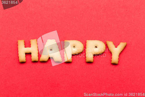 Image of Happy word cookie over the red background