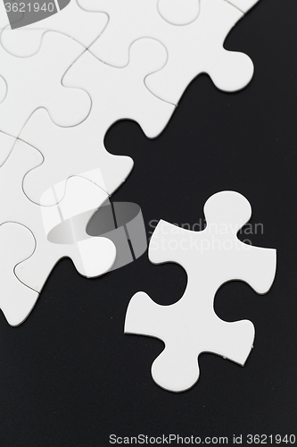 Image of White puzzle on black background