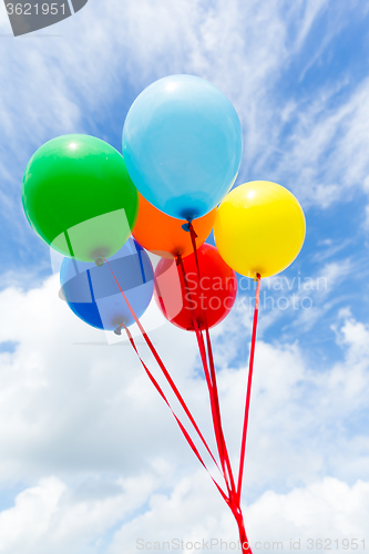 Image of Bunch of colorful balloons in blue sky