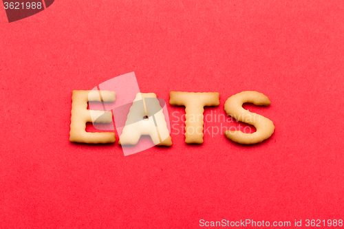 Image of Word eats biscuit over the red background