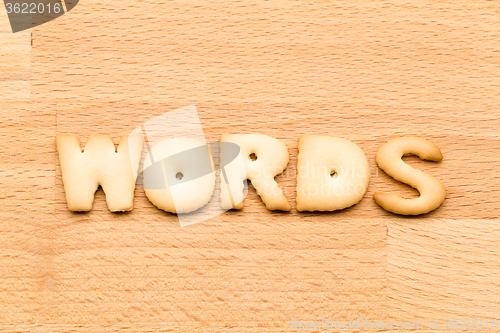 Image of Letter words biscuit over the wooden background