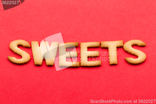 Image of Word sweets cookie over the red background