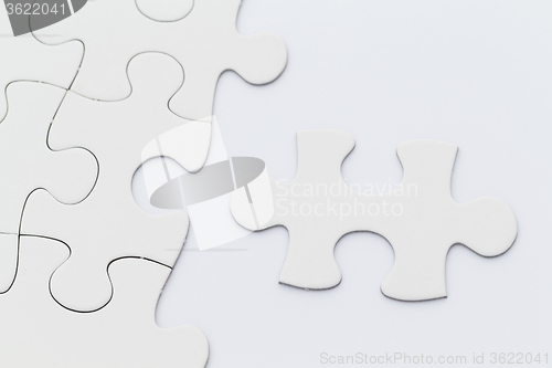 Image of White puzzle over the white paper