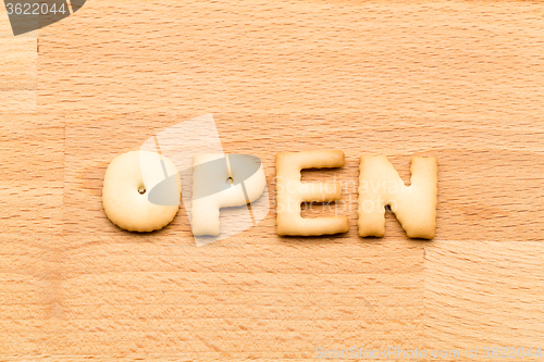 Image of Word open cookie over the wooden background