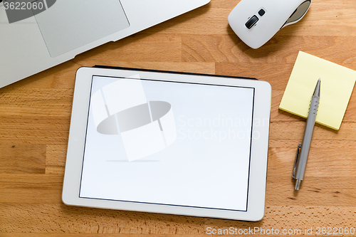 Image of Business office table with table pc presenting a blank screen fo