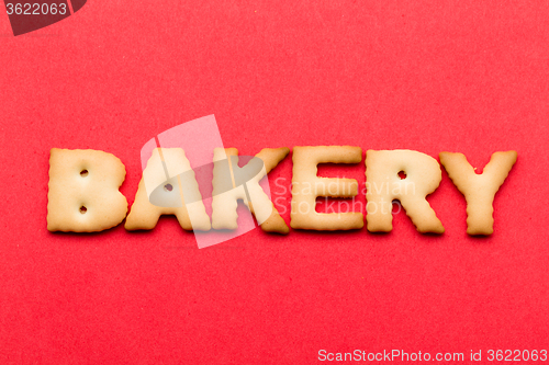 Image of Word bakery biscuit over the red background
