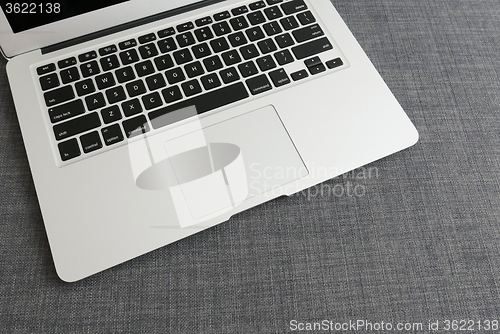 Image of Laptop on blue cloth background