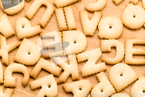 Image of Baked word biscuit over wooden table