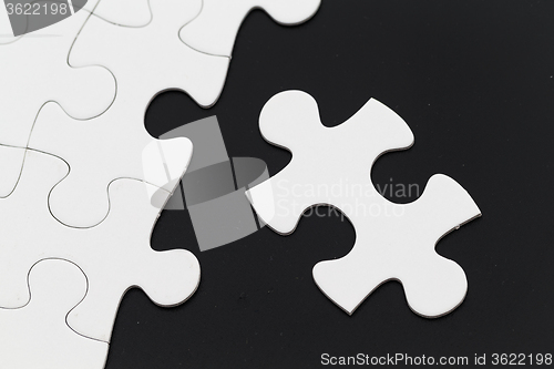 Image of Jigsaw puzzle on black background