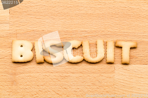 Image of Word biscuit over the wooden background